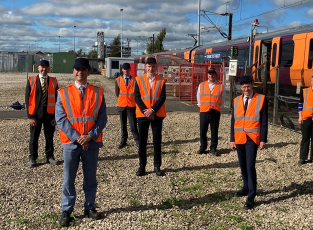 Workers in front of train