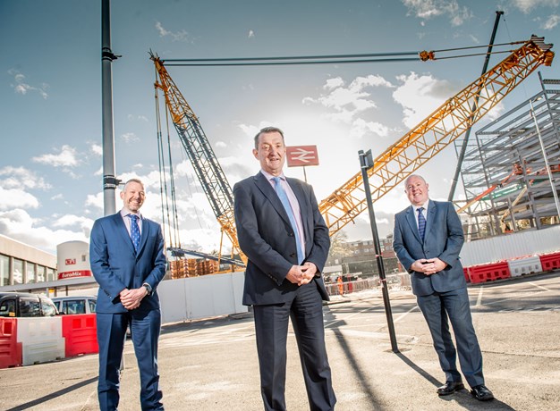 3 men in front of crane