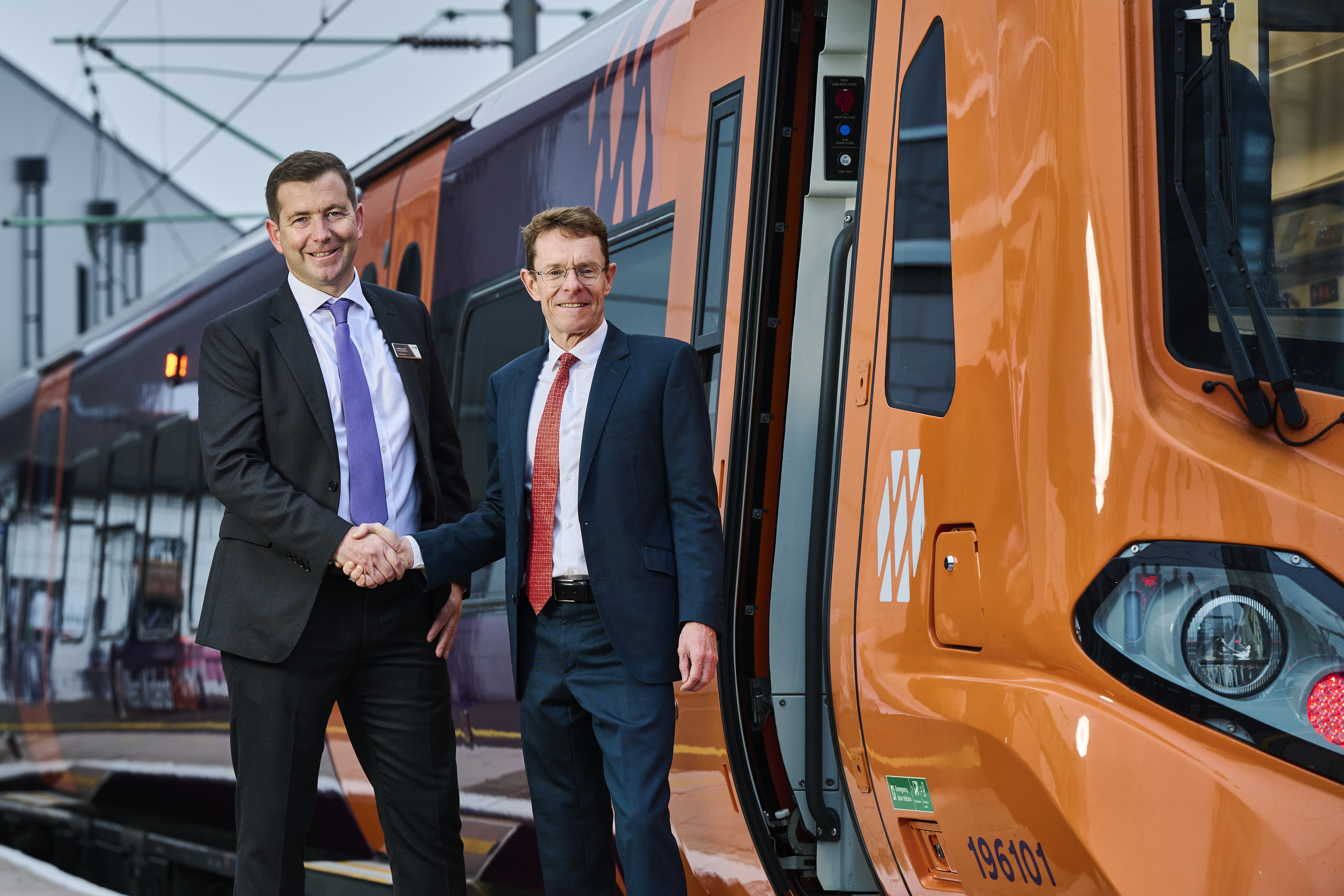 Mayor Andy Street standing outside a new West Midlands Railway train